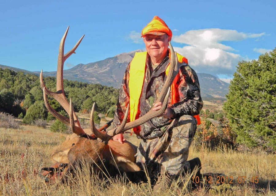 Hunter with a harvested bull elk.