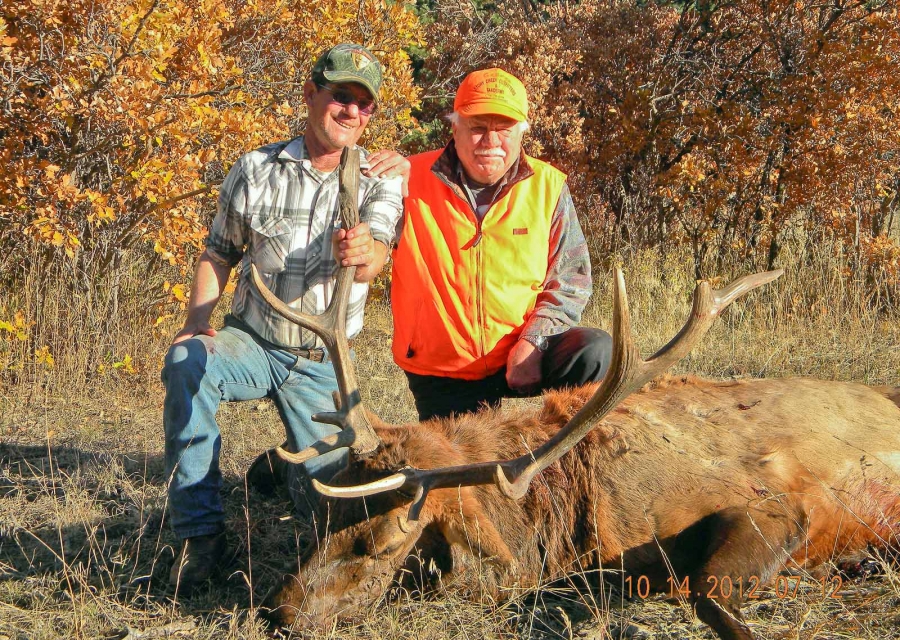 Hunter and guide with a harvested bull elk.