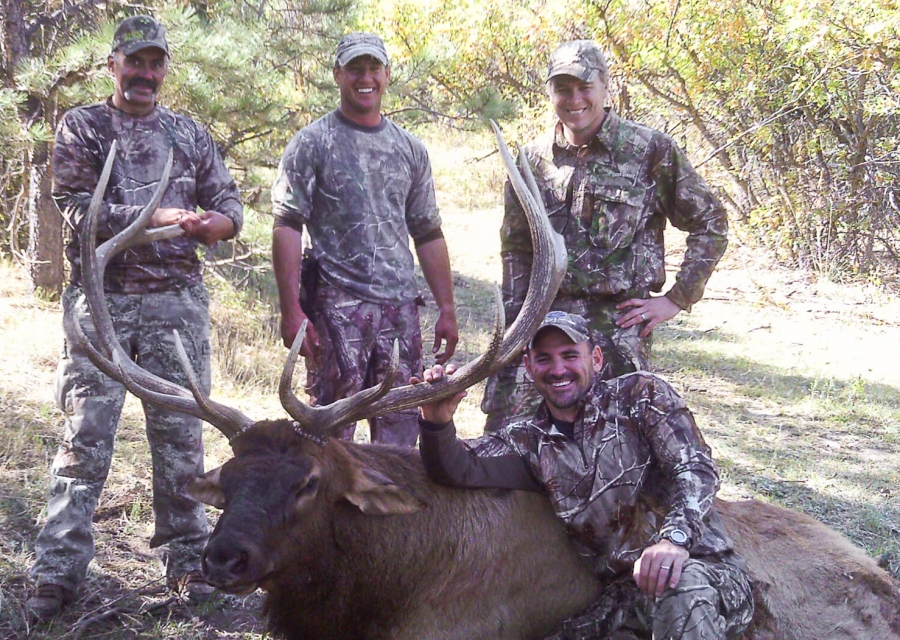 Happy hunters with a harvested bull elk.