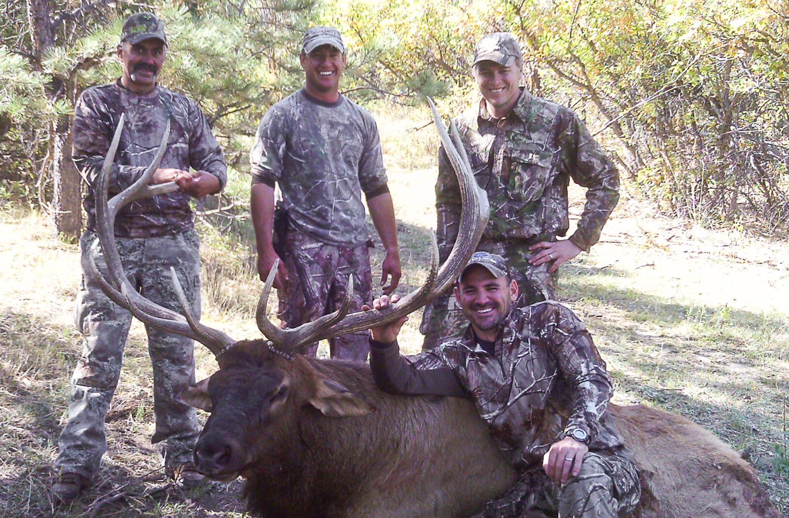 Happy hunters with a harvested bull elk.