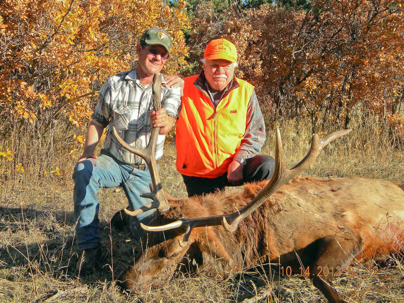 Hunter and guide with a harvested bull elk.